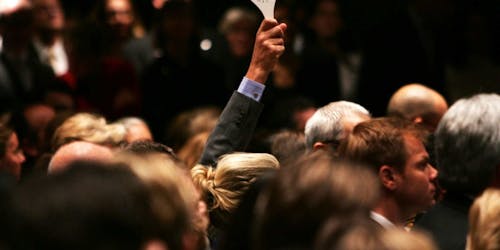 A paddle being held up at an auction. A paddle being held up at an auction.