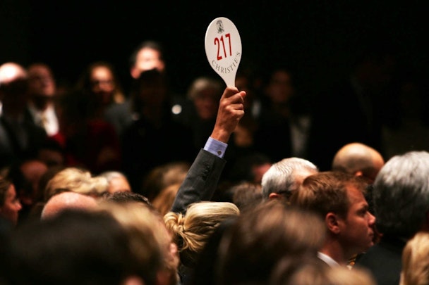 A paddle being held up at an auction.