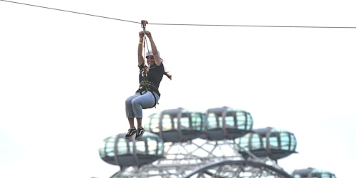A woman travelling down a zip line.