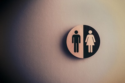 A men/women sign on a wall.