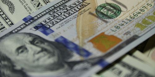 Closeup shot of hundred dollar bill featuring Benjamin Franklin's face