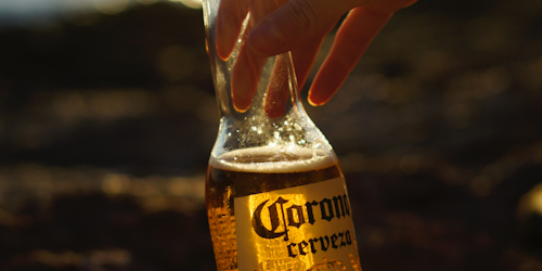 Corona beer bottle in hand