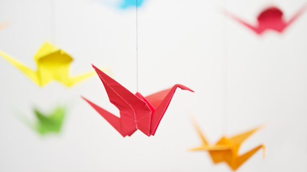 Origami cranes suspended from string