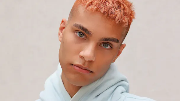 Young man with pink hair and baby blue hoodie on