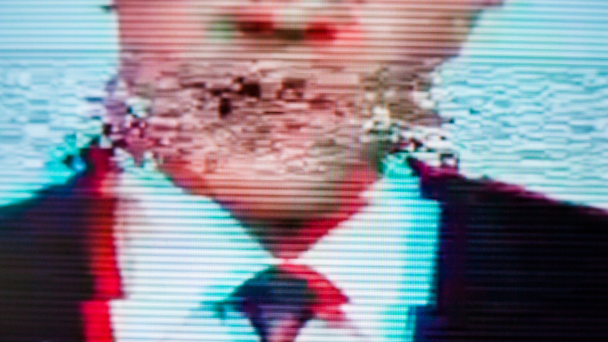 TV glitching while man in suit is talking