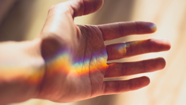 Rainbow refraction on palm of hand