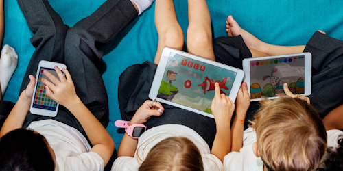 Kids playing mobile games on devices
