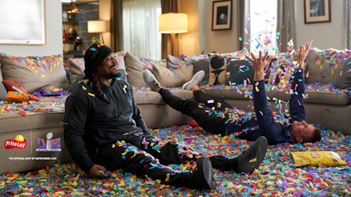Marshawn Lynch and Rob Gronkowski with confetti all over the floor