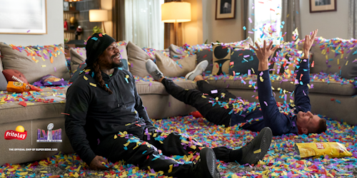 Marshawn Lynch and Rob Gronkowski with confetti all over the floor
