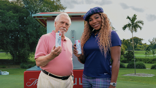 Brian Cox and Serena Williams holding Michelob Ultra beers on a golf course