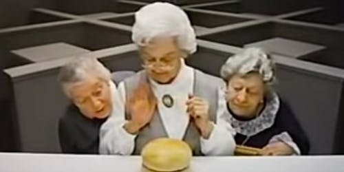Elderly ladies looking at hamburger bun Elderly ladies looking at hamburger bun