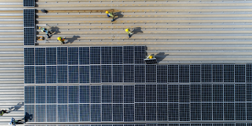 Solar panels being installed by construction workers 