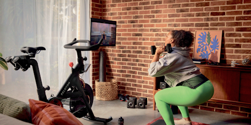 Woman works out with Peloton products