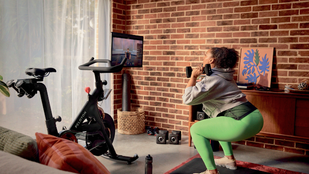 Woman works out with Peloton products