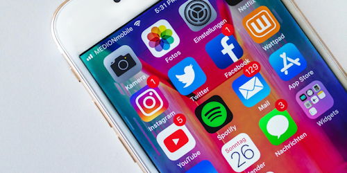 Mobile phone screen with social media app logos