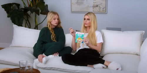 Jessica Simpson and daughter Maxwell sitting on white couch eating Chicken of the Sea tuna packet