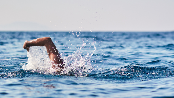 Man swimming through ocean water