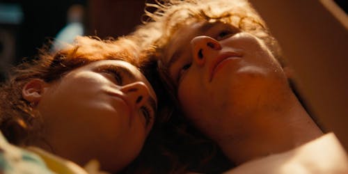 Boy and girl lying next to one another in the sunlight Boy and girl lying next to one another in the sunlight