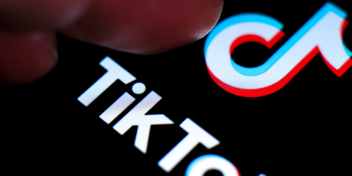 finger on TikTok logo
