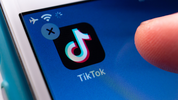 Finger over TikTok app