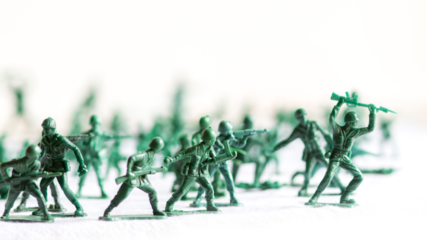 Green toy soldiers against white background