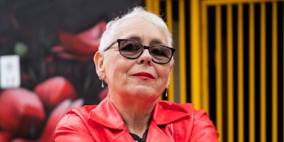 A stylish older woman in a red jacket