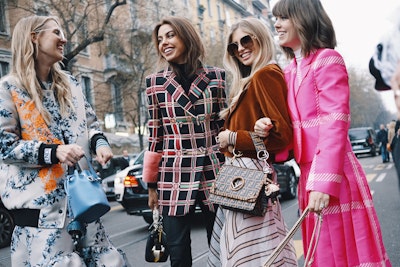 Four women in luxury fashions