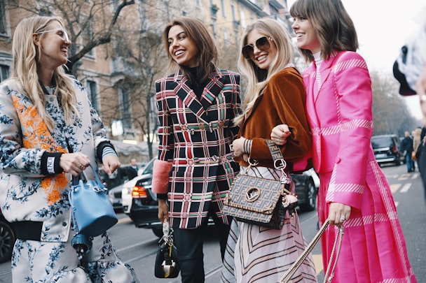 Four women in luxury fashions