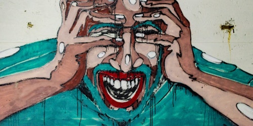 Graffiti of screaming man with his head in his hands