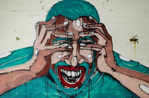 Graffiti of screaming man with his head in his hands