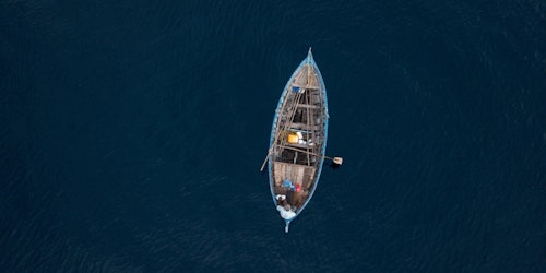 A small boat, at sea