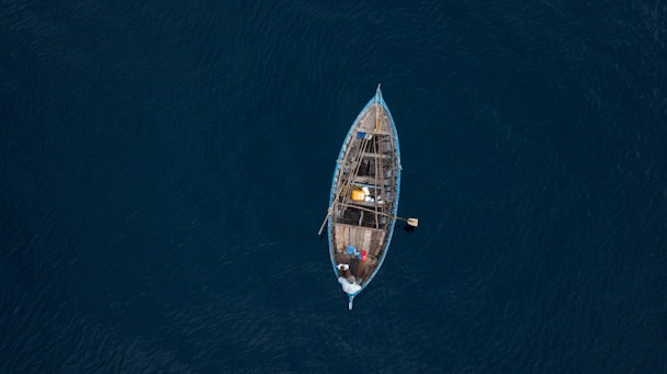 A small boat, at sea