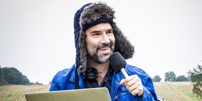 Adam Buxton recording a podcast in a field