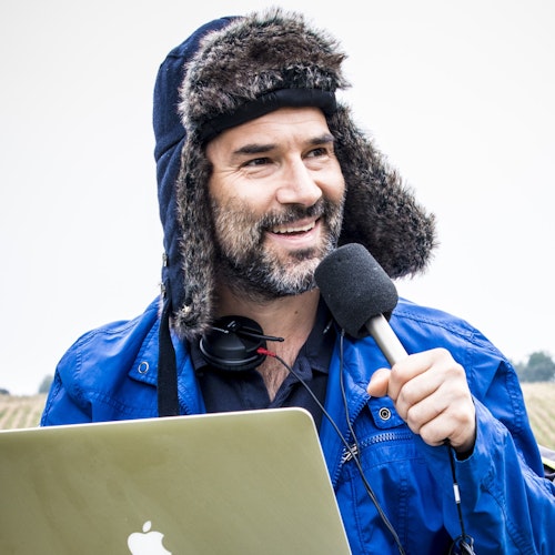 Adam Buxton recording a podcast in a field