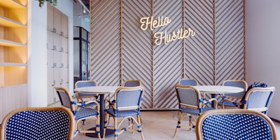 A painfully cool office environment, with a neon sign that reads "Hello Hustler"