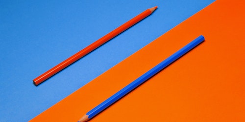 A red pencil on a blue background, and a blue pencil on a red background