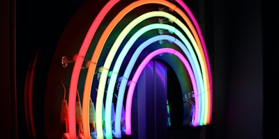 A neon sign in the shape of a rainbow
