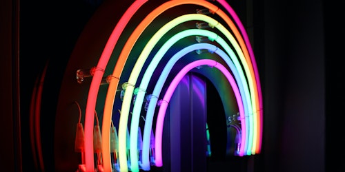 A neon sign in the shape of a rainbow