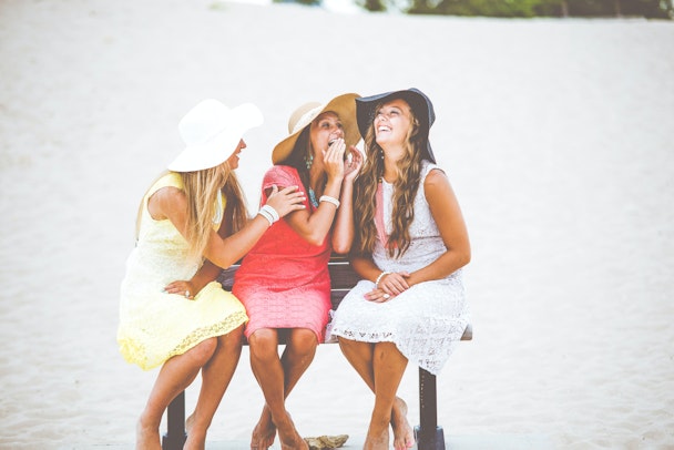 Three women, chatting on a bench