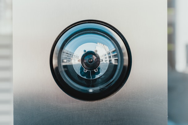 A surveillance camera set into a wall, up close