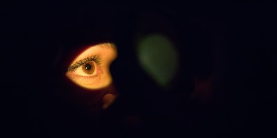 An eye lit up in the darkness