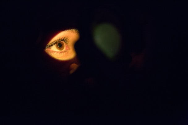 An eye lit up in the darkness