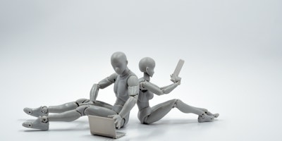 Two back-to-back grey mannequins, playing with grey tech