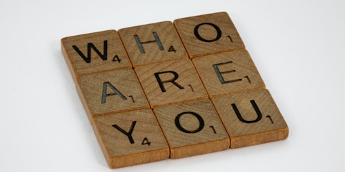 Scrabble tiles spelling out 'Who are you?'