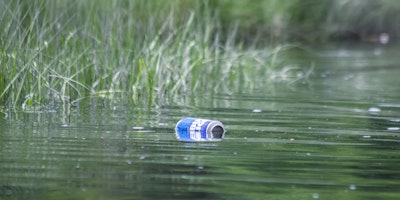 A can of Bud Light, rolling down a river