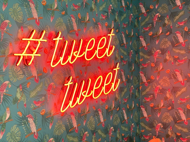 A neon sign that reads "#TweetTweet"