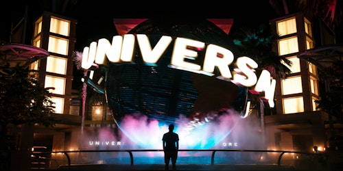 A figure in silhouette in front of a massive Universal Studios sign