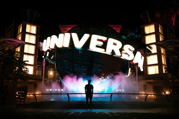 A figure in silhouette in front of a massive Universal Studios sign