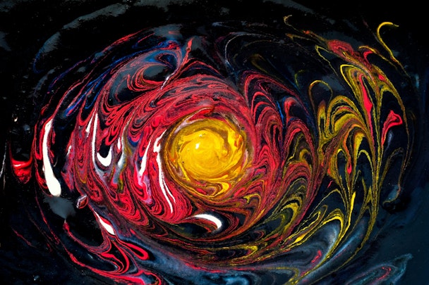 A swirl of oil-based paint, resembling the star at the center of a galaxy
