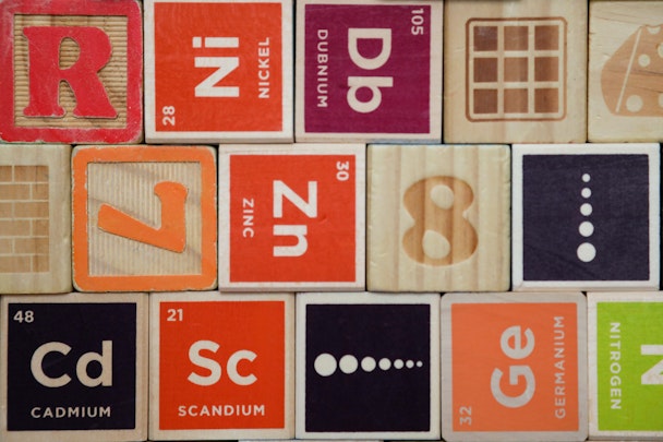 A stack of colorful wooden blocks depicting elements from the periodic table